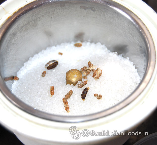 Add cardamom pods, grind to fine powder