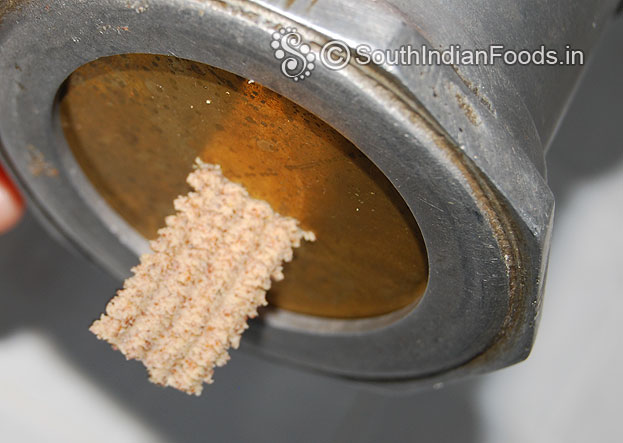 Fit pakoda mould in the murukku kuzhal then place lemon size dough & squeeze