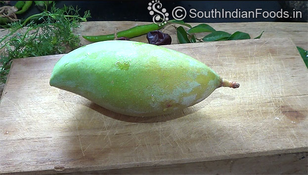 Take one raw mango, wash 