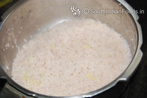 Pressure cook broken red rice, & moong dal with 1 tbsp of ghee for 4 whistles