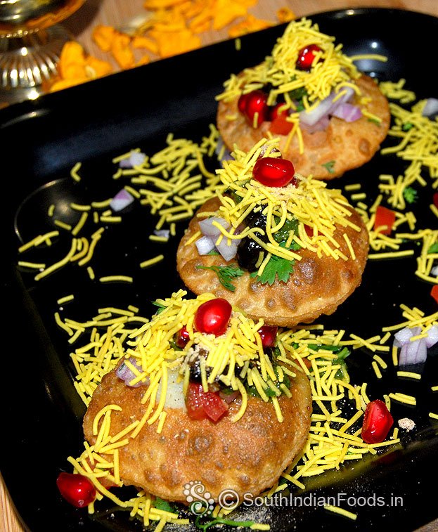 Add green chutney, tamarind chutney, sev, pomegranate