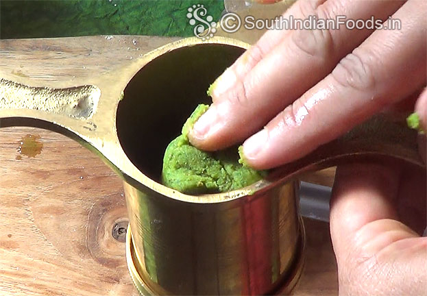 Place 1 handful dough into the murukku kuzhal
