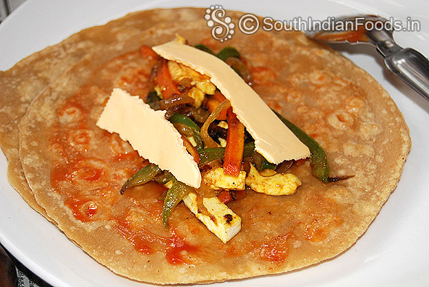 Add sauted veg, paneer and cheese slice