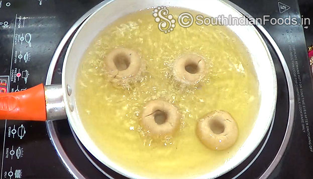 Heat oil, drop raw badusha