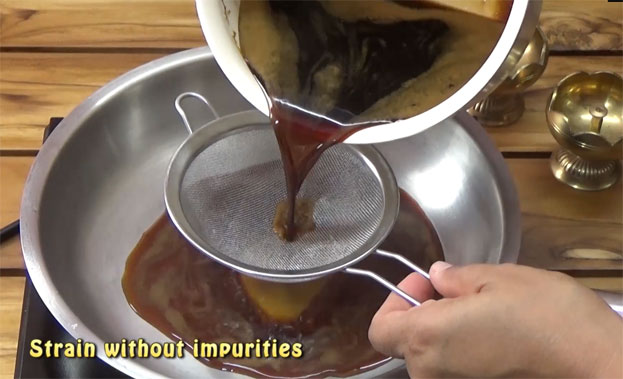 Heat broad pan, strain jaggery syrup without impurities