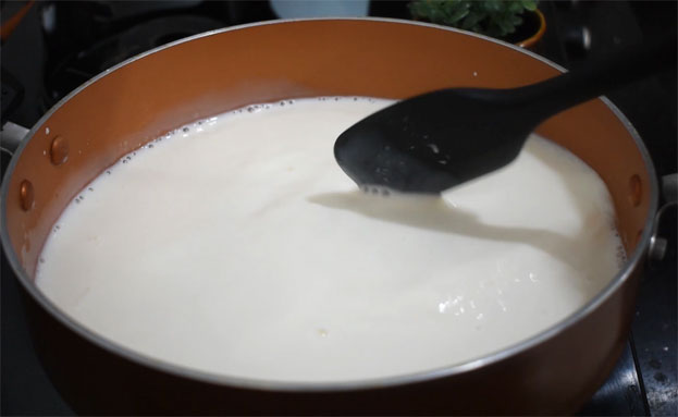 In a bowl add curd, cardamom, sugar