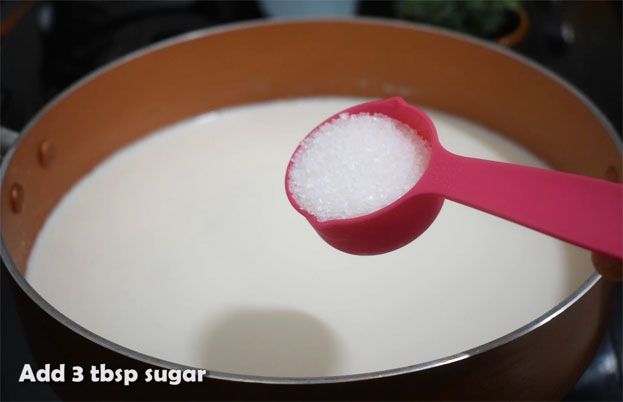 In a bowl add curd, cardamom, sugar
