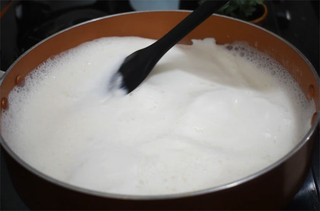In a bowl add curd, cardamom, sugar