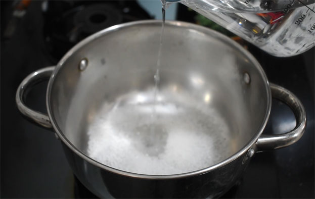 In a bowl add curd, cardamom, sugar