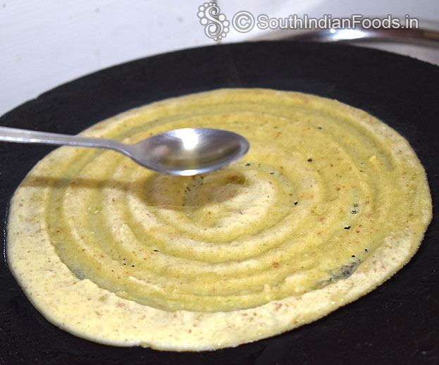 Pour 1 tbsp oil around the dosa