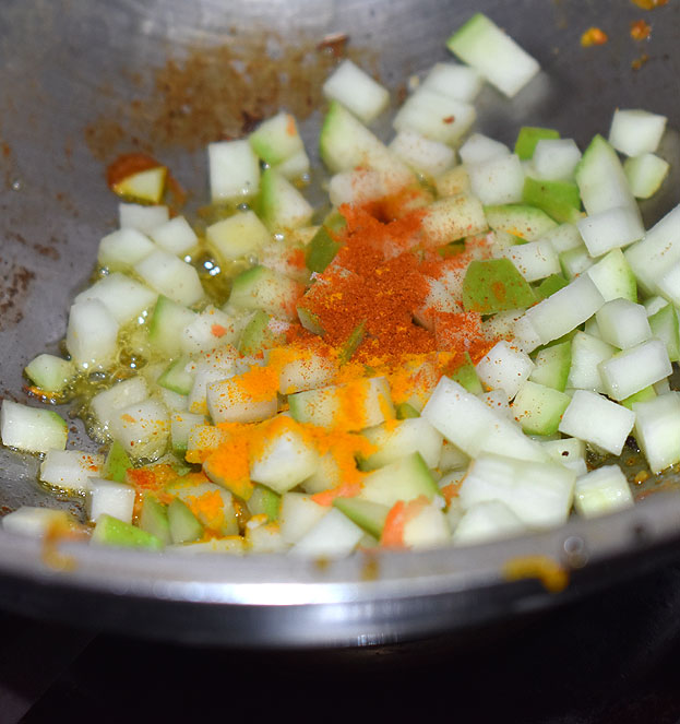 Heat raw mango, red chilli powder, turmeric powder