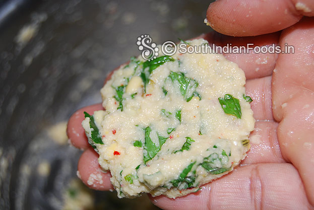 Take lemon size portion of mixture, flatten & shape vada