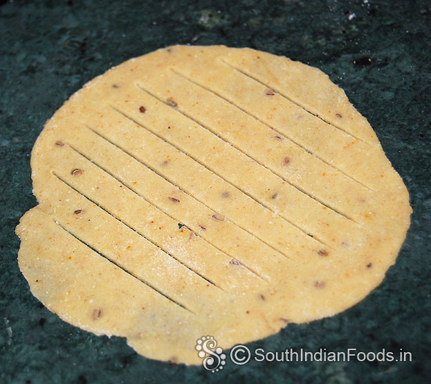 Roll out into thin chapathi, cut stripes in the middle