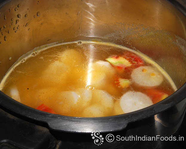 Heat pressure cooker add toor dal, tomato, onion, garlic, turmeric, green chilli, gingelly oil 