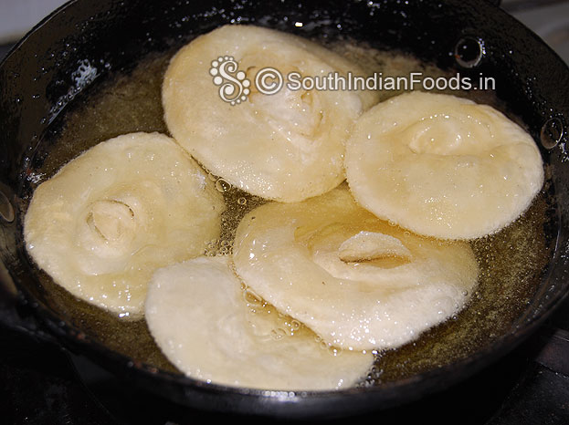 Heat oil in a pan, add layered poori, deep fry till crisp and golden brown on medium hot oil