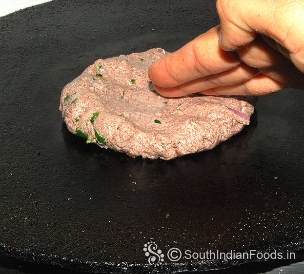 Dip fingers in water, spread on the hot dosa tawa