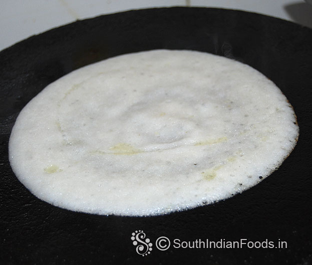 Pour 1 tbsp oil around the dosa