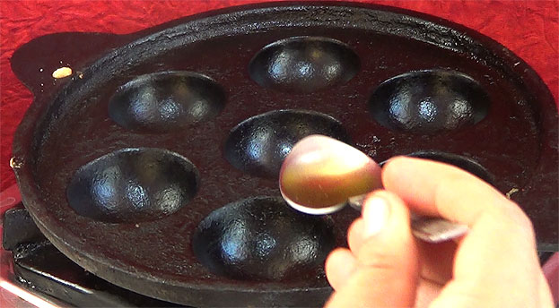 Heat iron paniyaram pan, add oil