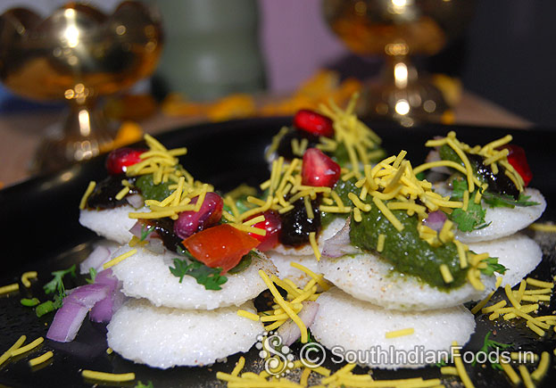 Add onion, tomato, coriander, green chutney, tamarind chutney, pomegranate, chat masala and sev