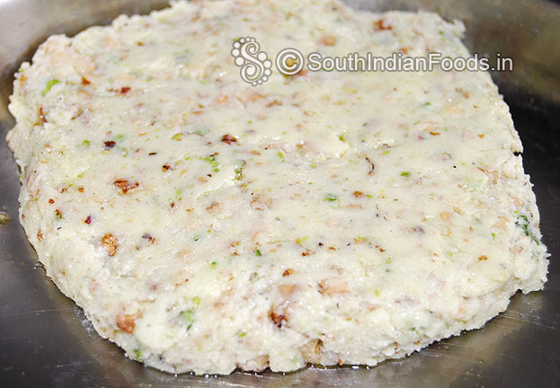 Transfer the mixture to a ghee greased tray & evenly spread