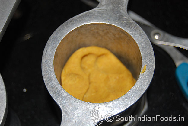In a muruku kuzhal add one handful of dough.