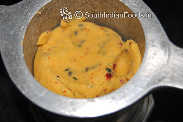 Put one handful dough in to the muruku kuzhal then press