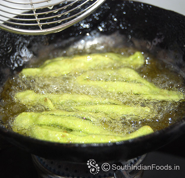 Heat oil, drop raw champakali, deep fry till crisp