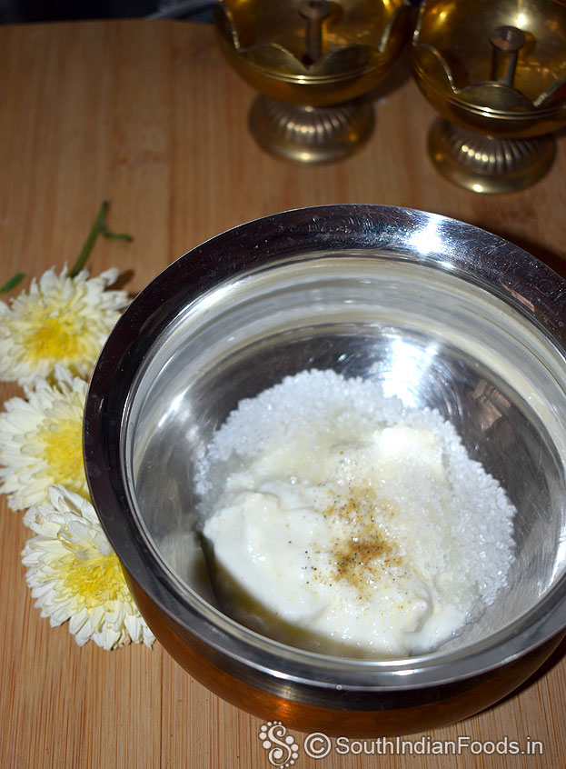 In a bowl add fresh curd, cardamom powder & sugar