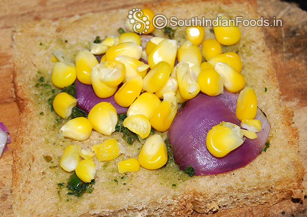 Take a bread slice, grease green chutney, onion & boiled babycorn then sprinkle salt & pepper