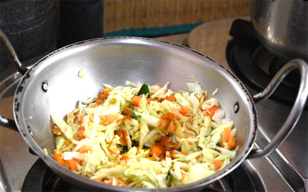 Add carrot , cabbage, red chilli powder, salt