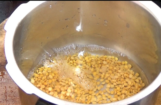 Add toor, water in a pressure cooker