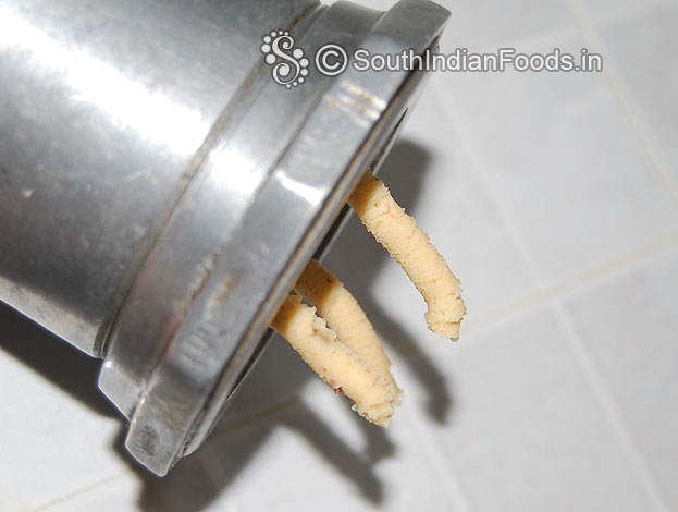 Put dough in a murukku kuzhal & gently press